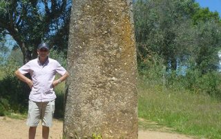 Bob standing near ancient rock art